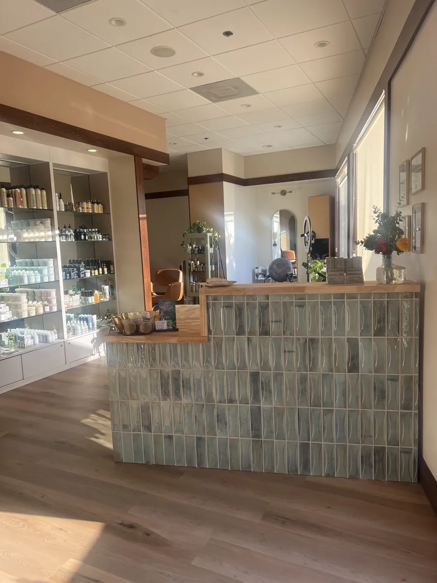 A tiled service counter with a wood top in a retail shop