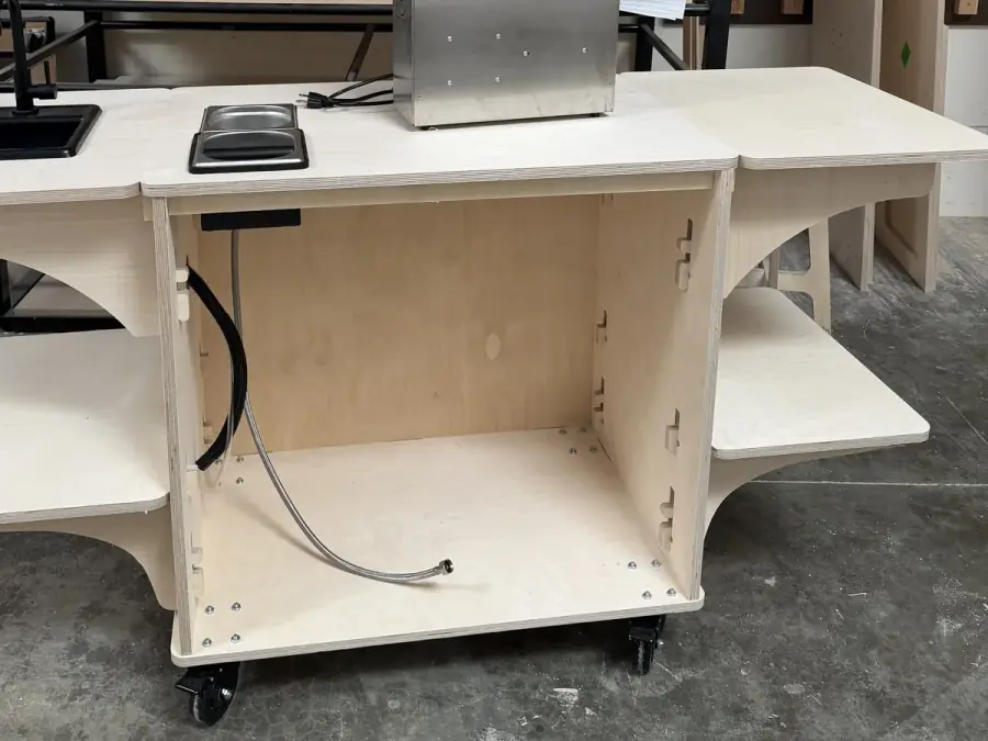 The same birch coffee cart mid-build, its cabinet open with the plumbing run inside
