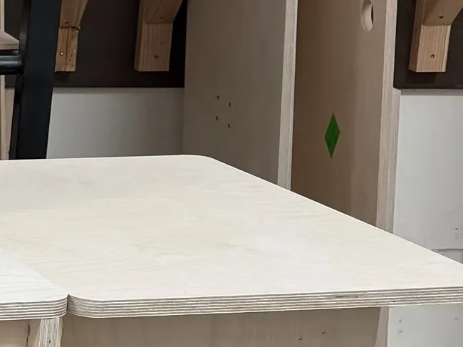 Close view of a sanded birch top and its rounded corner