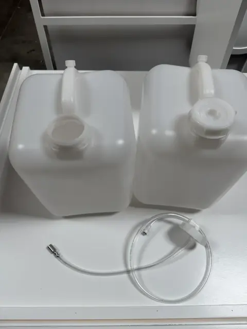 Two water jugs and the connecting tubing from the water jug kit